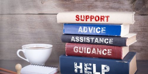 Support concept. Stack of books on wooden desk Support concept. Stack of books on wooden desk